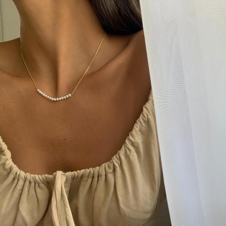 Gold Pearl Necklace Enhancing a Woman's Look