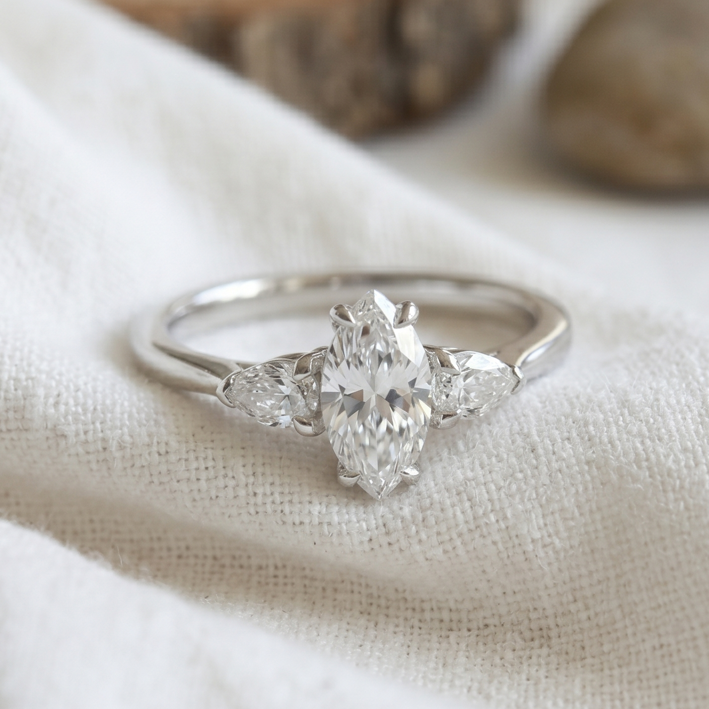 Marquise * pear cut diamonds in a white gold three stone engagement ring.