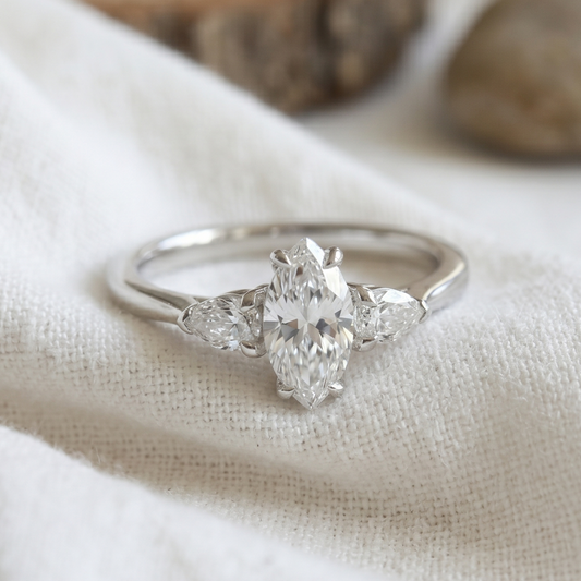 Marquise * pear cut diamonds in a white gold three stone engagement ring.