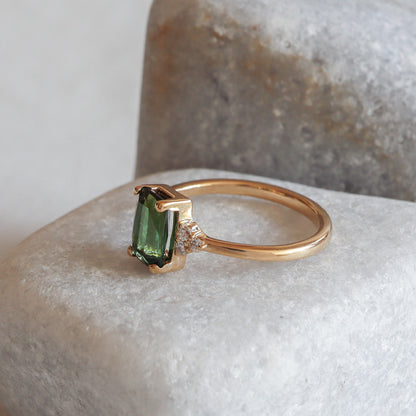 Green tourmaline and diamonds on a yellow gold band.