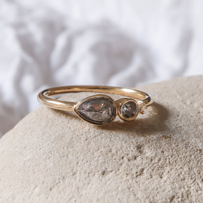 מבט מהצד על שיבוץ הכוס המגן של יהלומי המלח-פלפל, המדגיש את הגימור המבריק של הזהב.