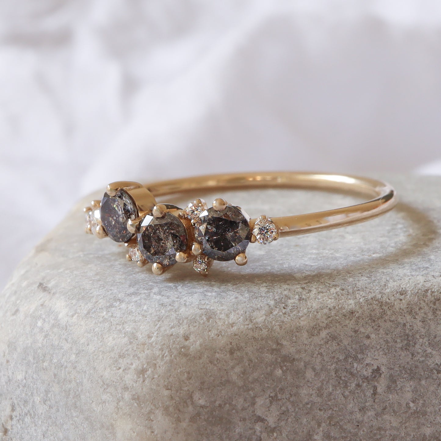 קלאסטר גיאומטרית מונחת על רקע ניטרלי, המבליטה את הנוכחות הויזואלית העשירה של שילוב היהלומים.