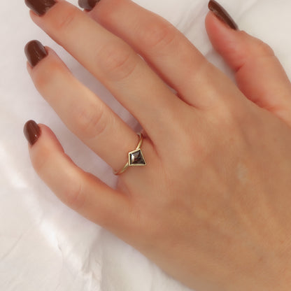 Solid gold matte finish ring with a salt pepper kite shape diamond set in a bezel setting.