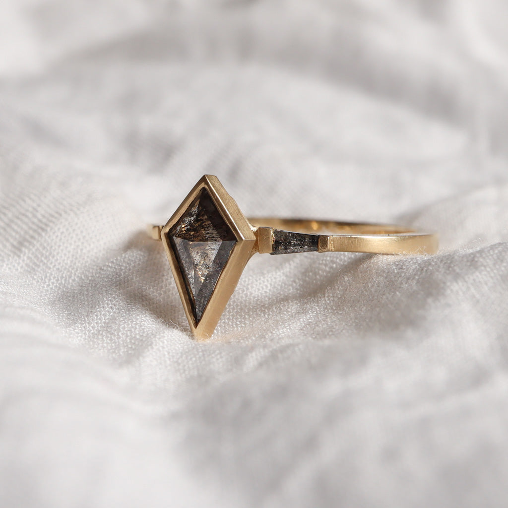 Three-Stone diamond ring features slat and pepper diamonds - Kite & Tapered baguettes in yellow gold with matte finish.