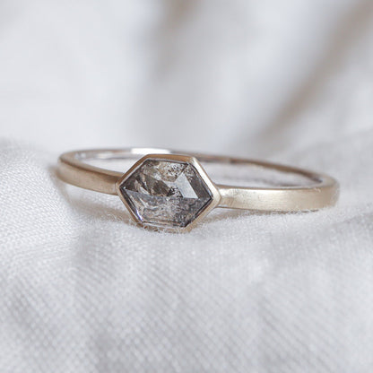 Salt and pepper diamond ring with a hexagon cut in a bezel setting, 14k matte champagne gold.