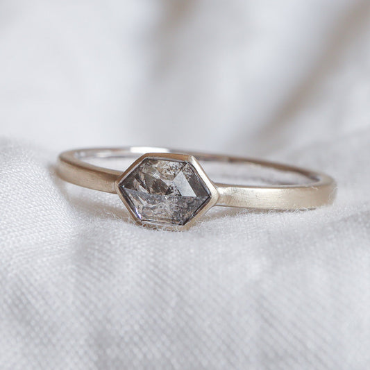 Salt and pepper diamond ring with a hexagon cut in a bezel setting, 14k matte champagne gold.