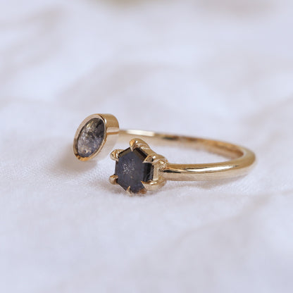 Angle view of the open yellow gold ring highlighting the six-prong setting of the dark hexagon diamond.