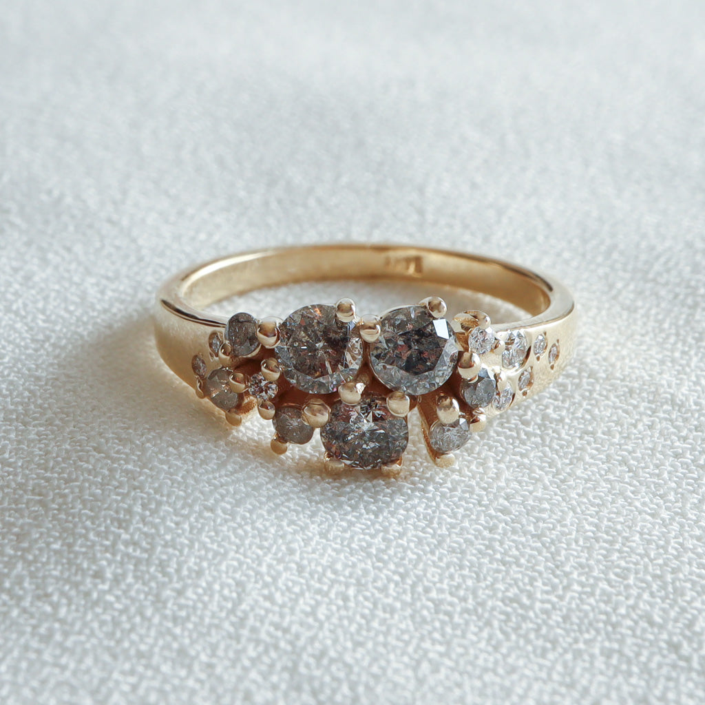 Galaxy cluster Salt & Pepper Diamond ring in 14K yellow gold, front view on white fabric – Dina Jewelry