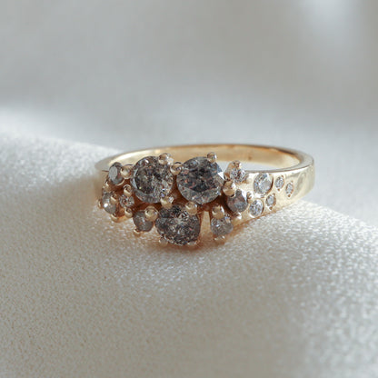 Close-up of the Galaxy ring: Salt & Pepper and white diamonds set in a 14K yellow gold band – Dina Jewelry