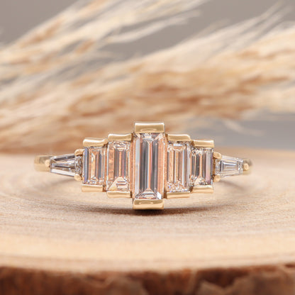 Diamond Baguette Gold Ring with Bezel-Set Vertical Step Design displayed on wooden surface, front view.