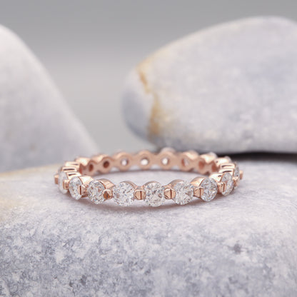 Dainty eternity bubble ring featuring round diamonds in rose gold.