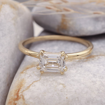 Diamond Emerald Cut Engagement Ring on a sleek grey stone background.