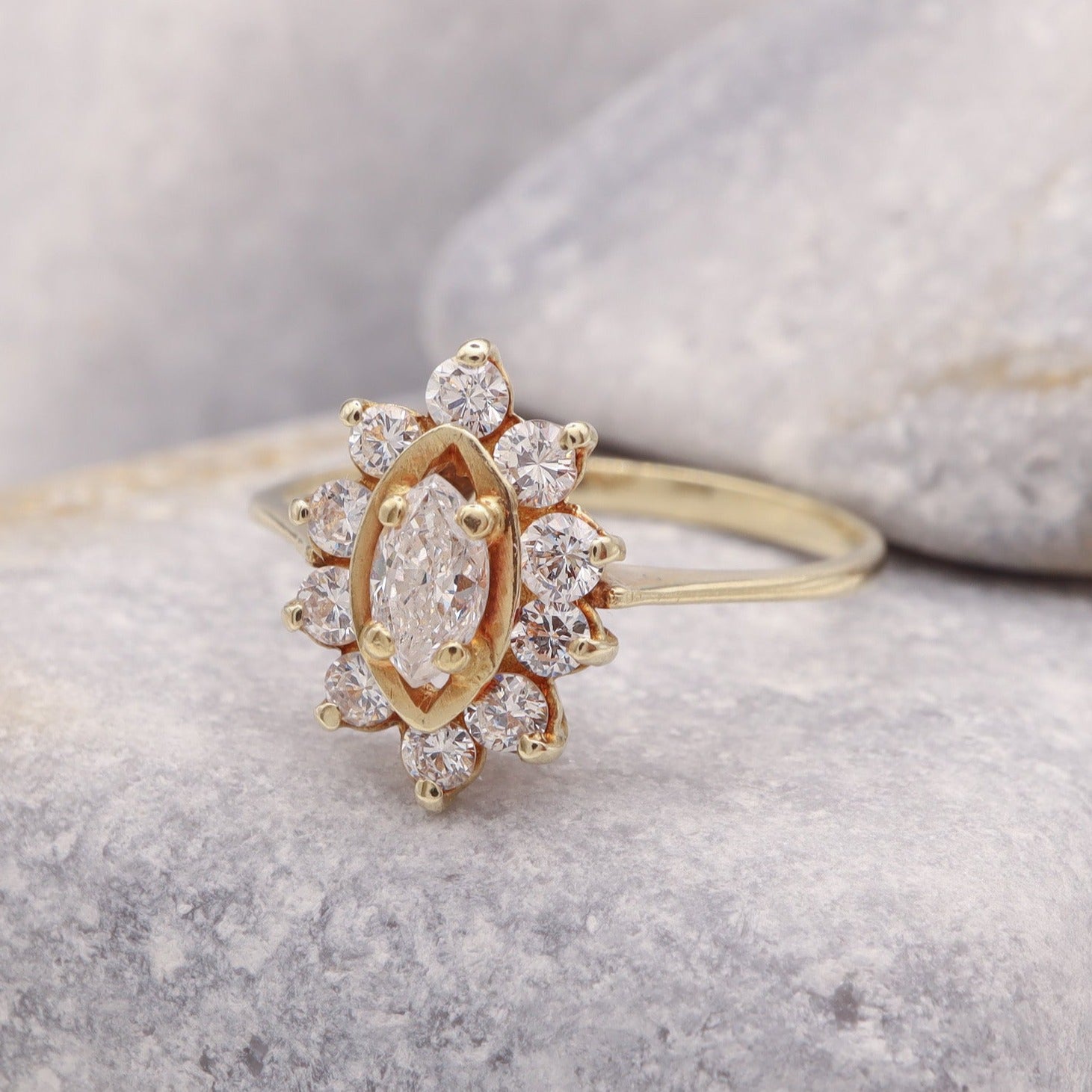 Marquise diamond engagement ring with vintage-inspired flower halo setting, crafted with care for timeless elegance.