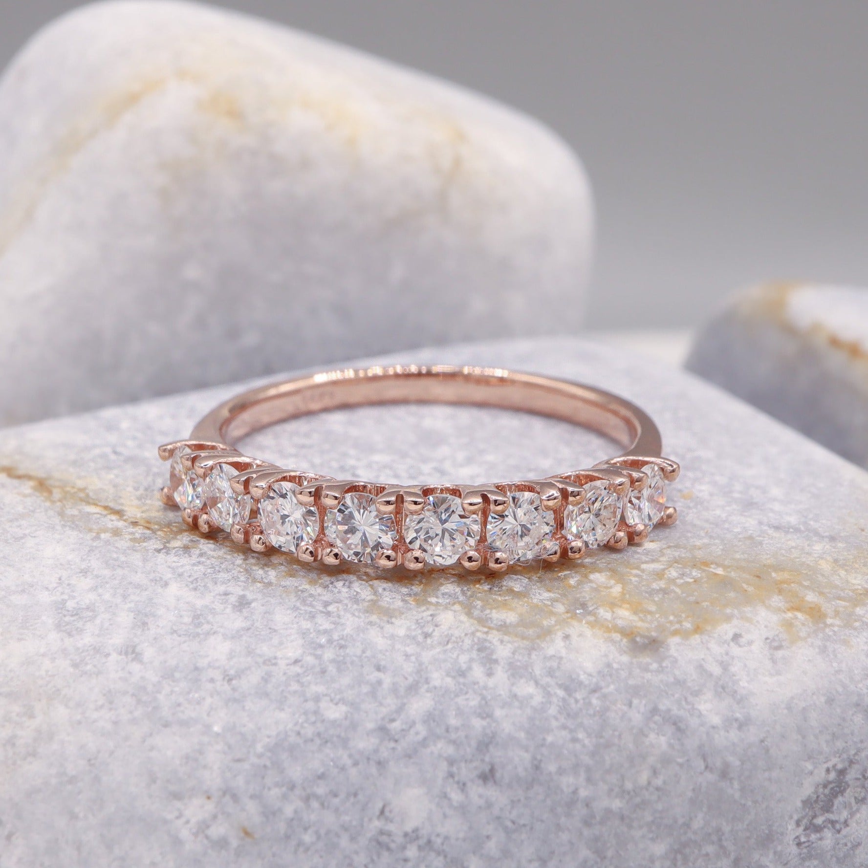 Stunning rose gold Delicate Diamond Half Eternity Ring, featured on a sophisticated grey stone.