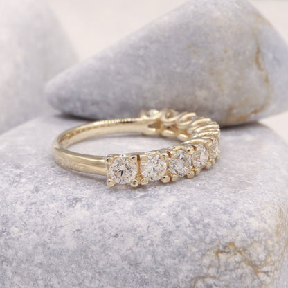 Side view of our diamond eternity ring in yellow gold.