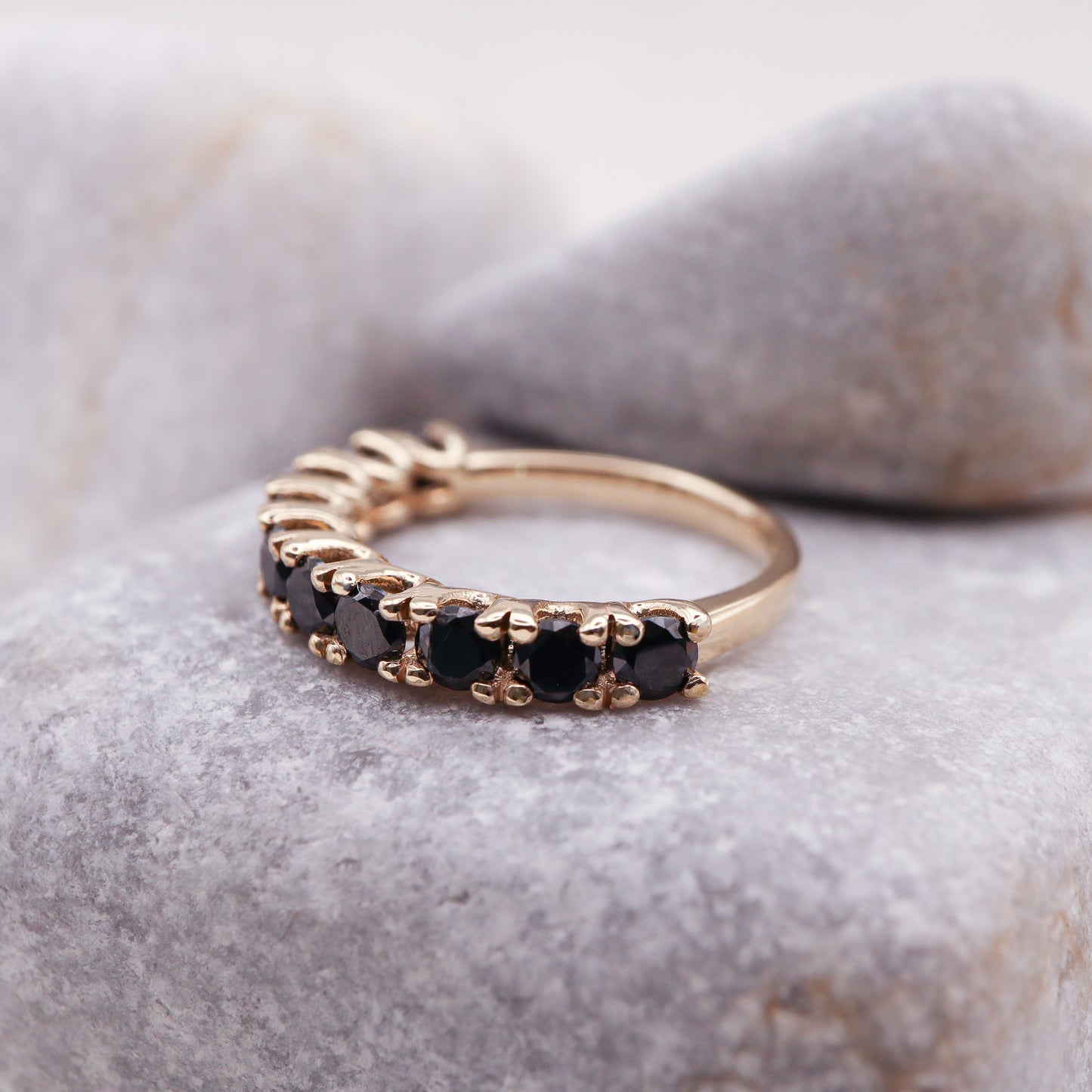 Profile view of our eternity band featuring black diamonds.