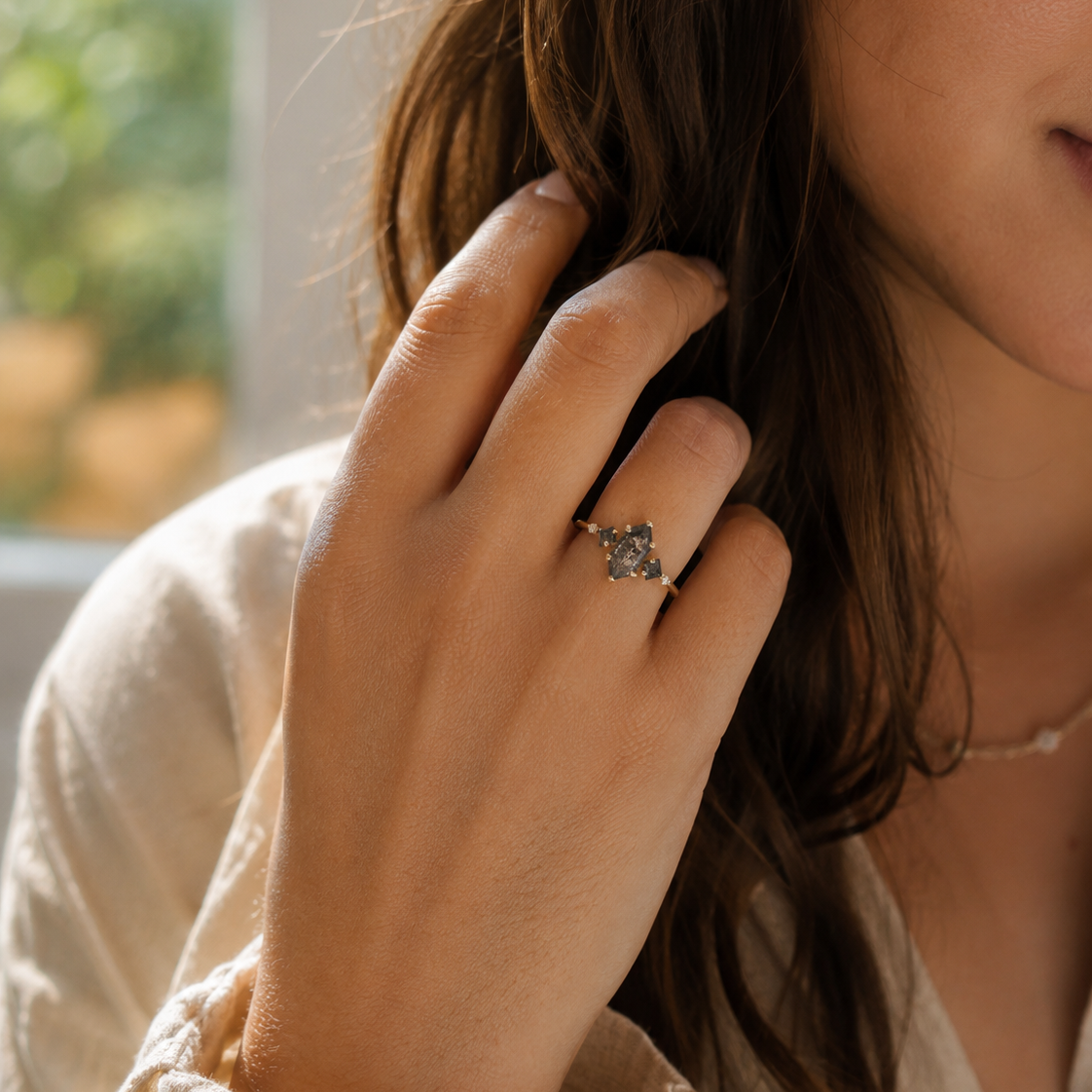 Salt pepper hexagon diamonds accented with two salt pepper princess cuts and clear white round diamonds on a 14k yellow gold ring.