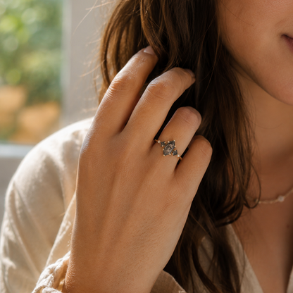 Salt pepper hexagon diamonds accented with two salt pepper princess cuts and clear white round diamonds on a 14k yellow gold ring.