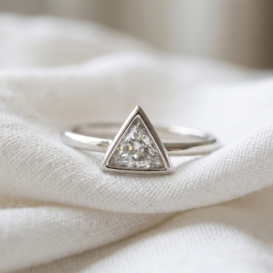 Triangle cut diamond in a white gold bezel setting engagement ring