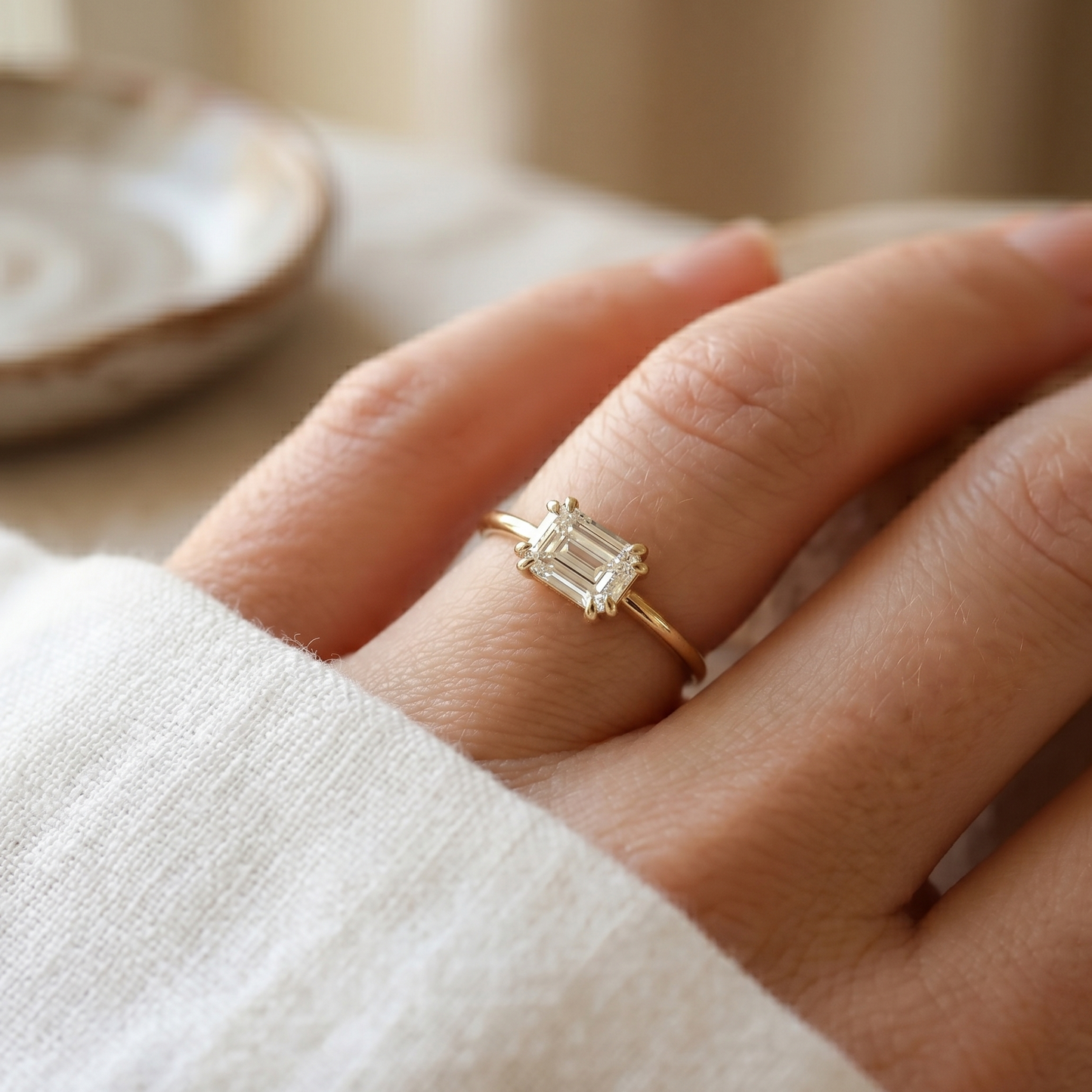 gold engagement ring featuring and emerald diamond  in a double prong setting.