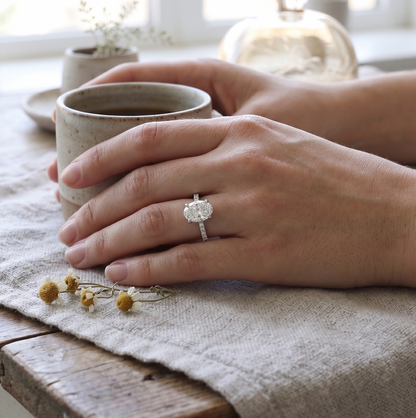 engagement ring with an oval diamond in white gold on a woman's ring.