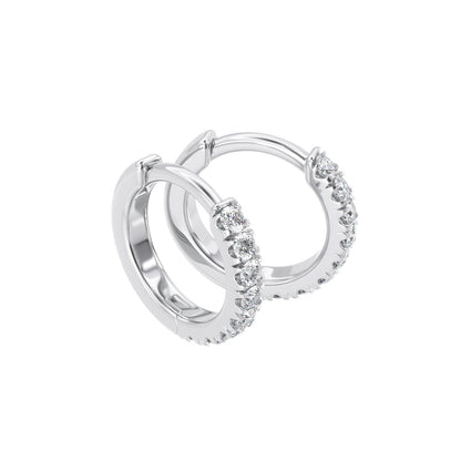 Profile view of Diamond Huggie Earring with diamonds in a pave setting on a solid white gold hoop, displayed against a white background.