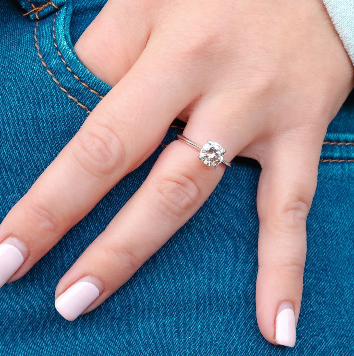 White Gold Solitaire Ring with Round Cut Diamond beautifully worn by a woman