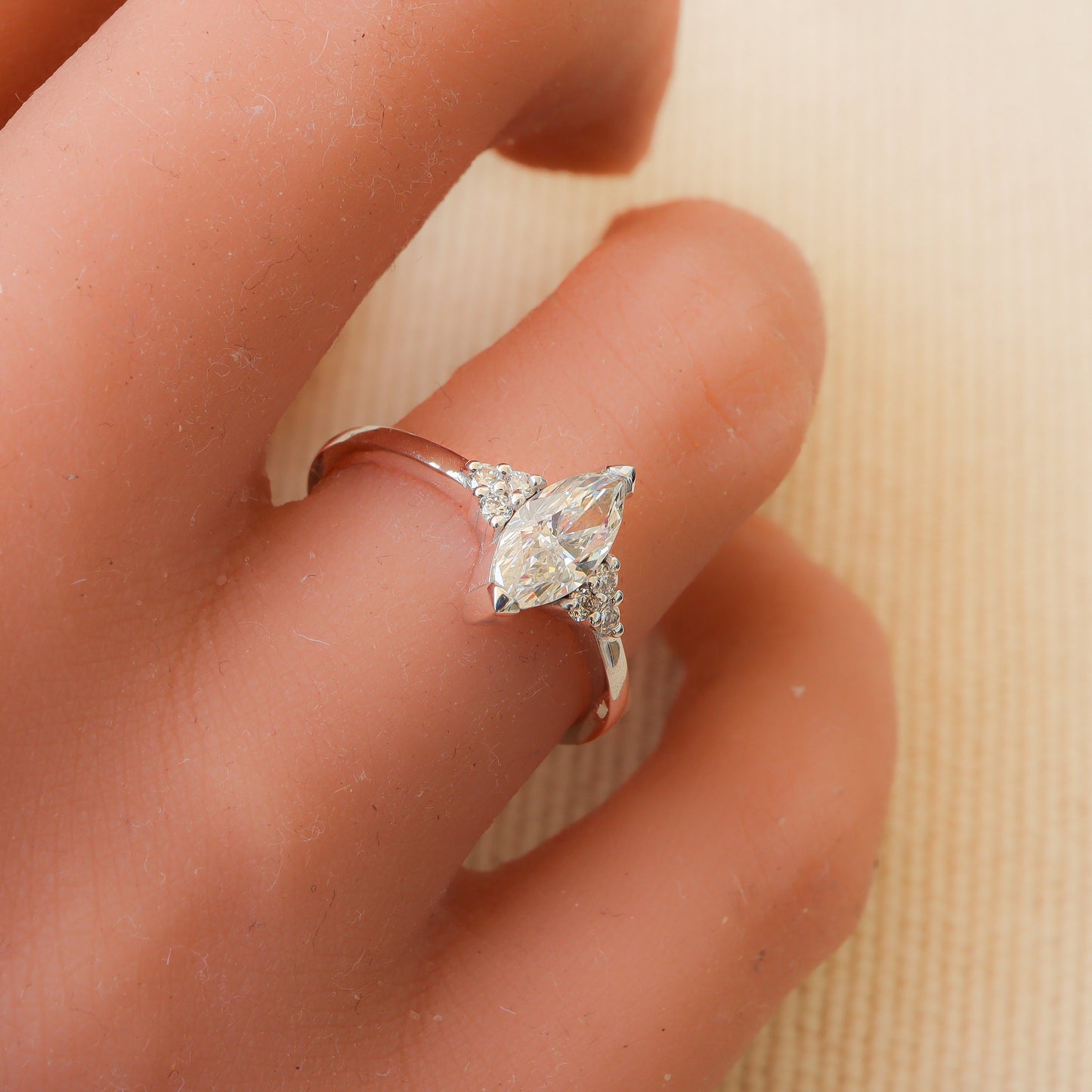 Graceful Marquise Diamond Ring in White Gold, delicately adorning a woman's finger with a mesmerizing tension setting