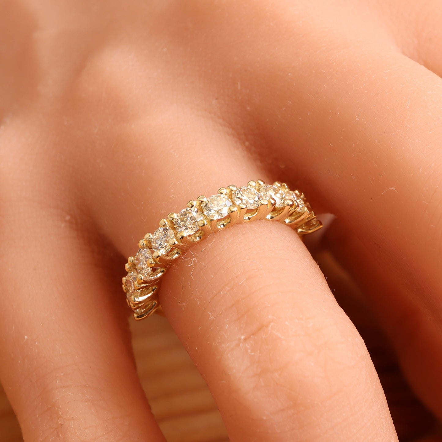 Diamond Eternity Half Gold Ring on Woman's Hand, Close-Up View from Above