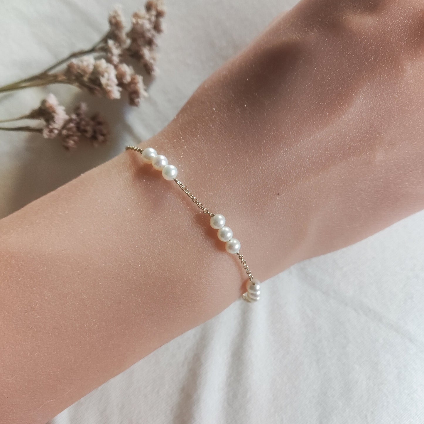 Graceful Three Pearl Station Bracelet in gold, beautifully worn on a lady's wrist