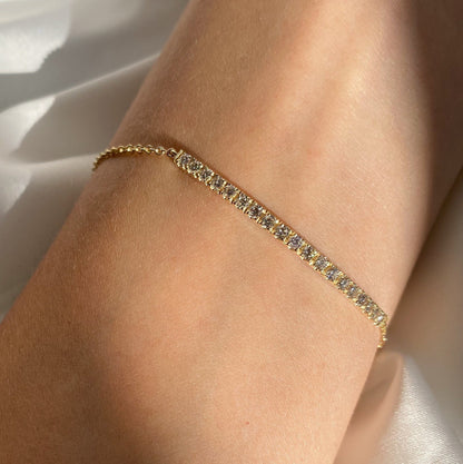 Half Diamond Bar Bracelet in Solid Gold elegantly worn on a woman's wrist