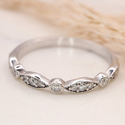 Eternity Band with Marquise & Round Diamonds displayed on a white marble slab