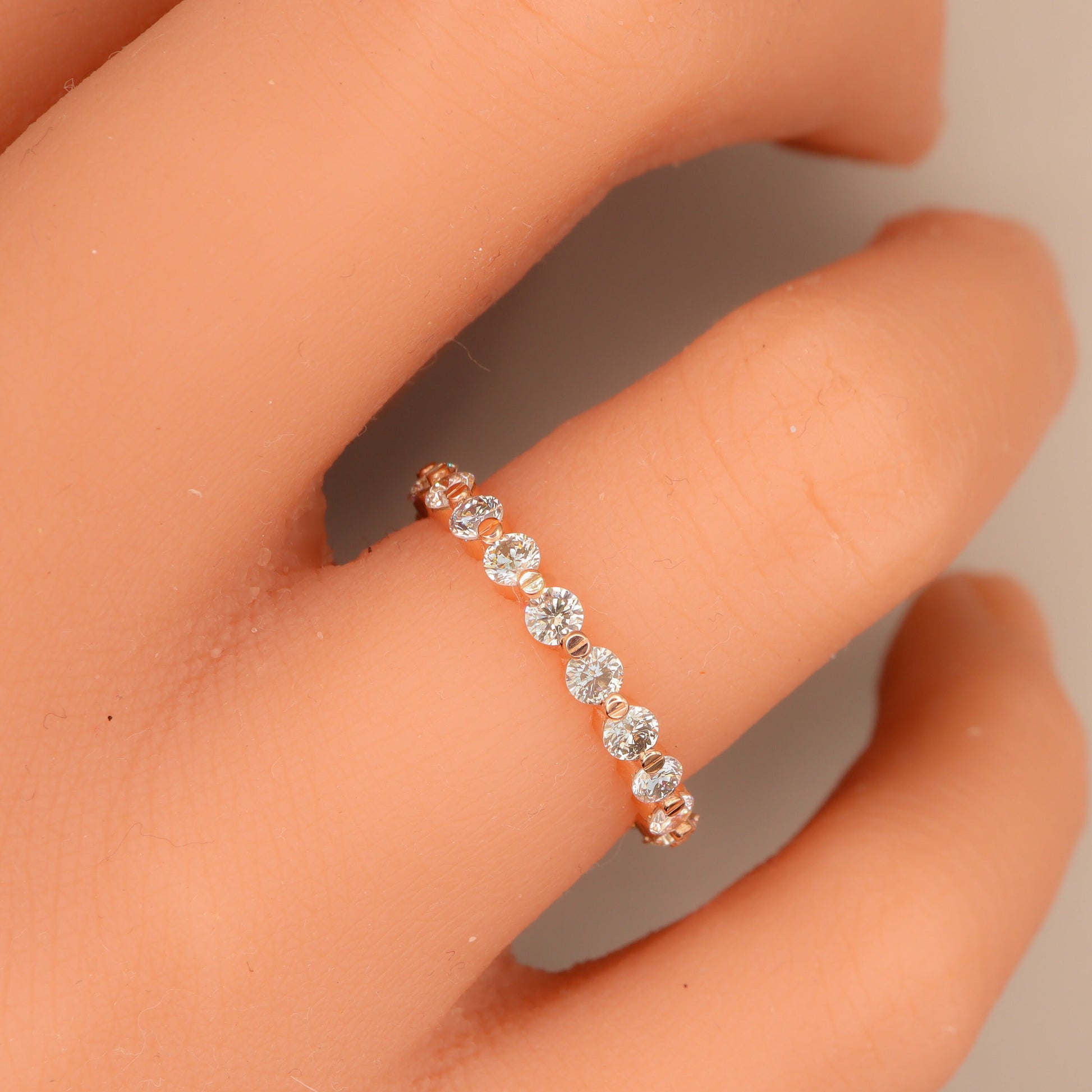 Rose Gold Diamond Eternity Ring elegantly worn on a woman's hand