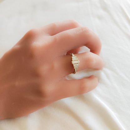 Diamond Baguette Gold Ring with Bezel-Set Vertical Step Design gracefully worn on a woman's hand.