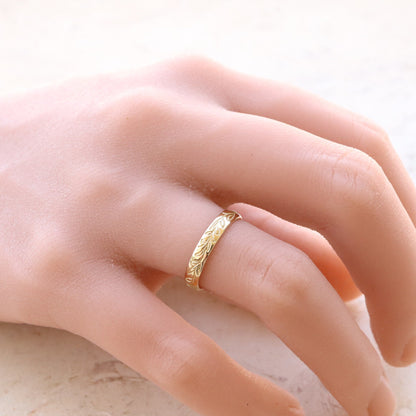 Graceful Gold Leaf Wedding Band adorning a woman's hand